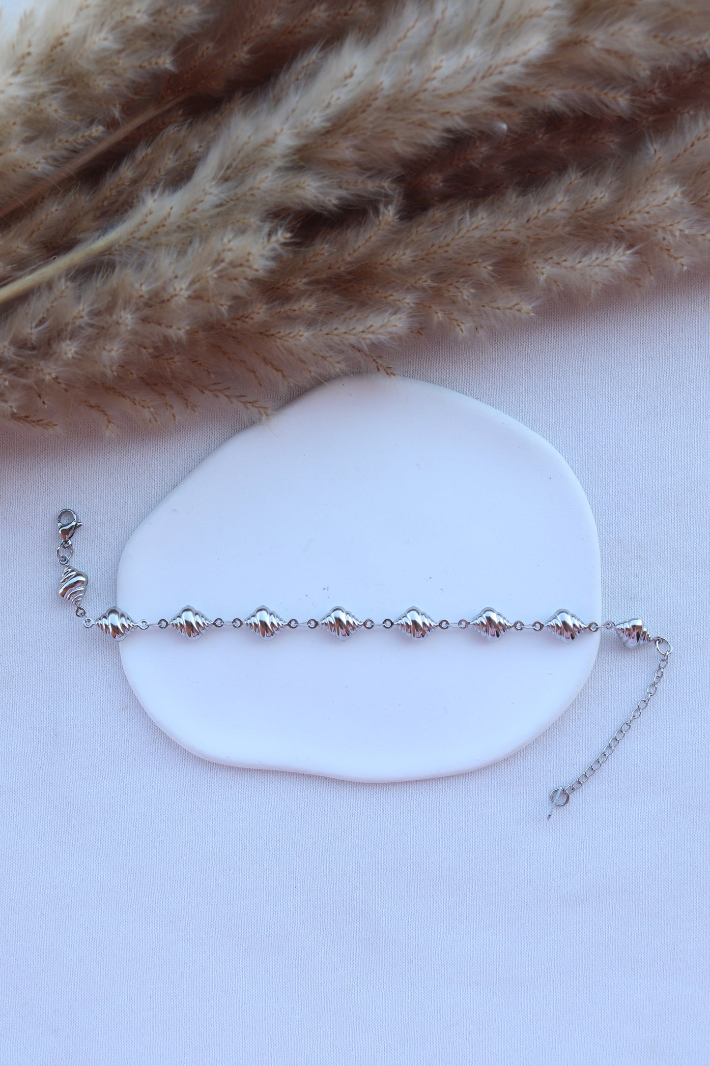 Pulseira de Aço Prateado de Pé de Búzios