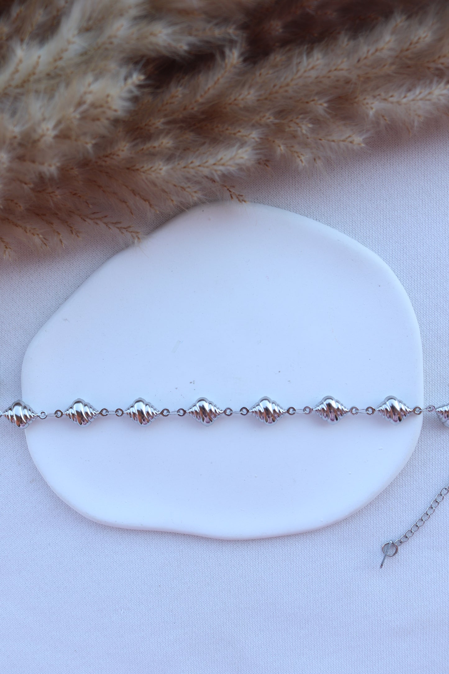 Pulseira de Aço Prateado de Pé de Búzios
