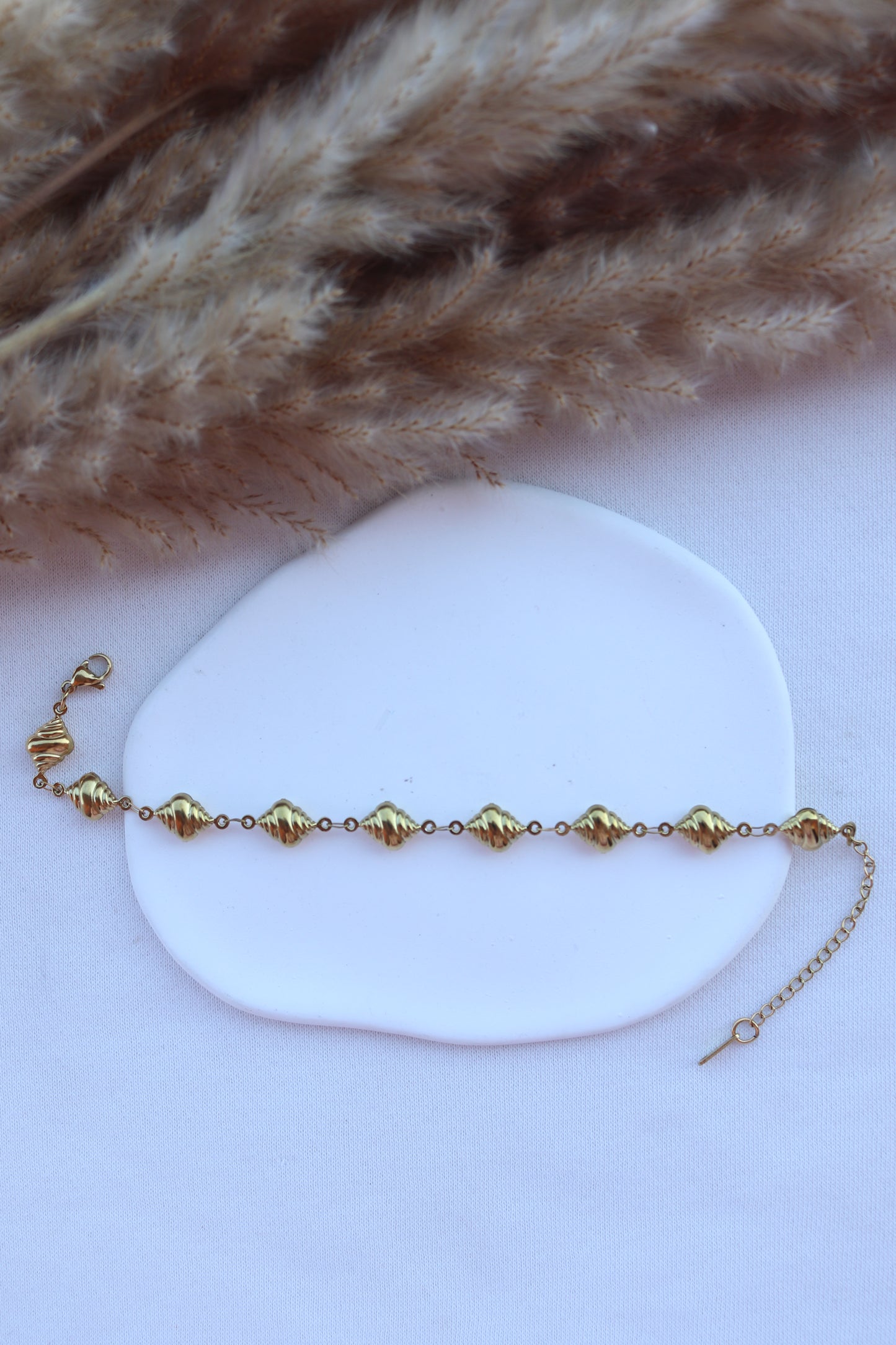 Pulseira de Aço Dourado de Pé de Búzios