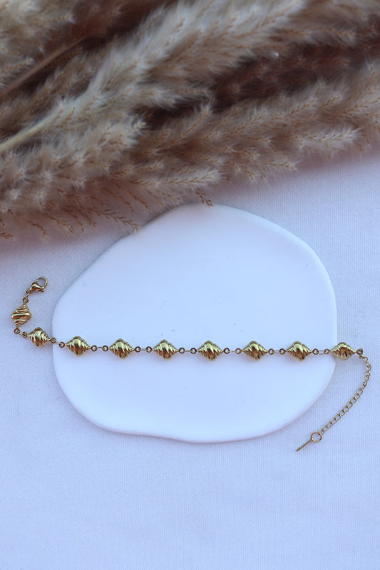 Pulseira de Aço Dourado de Pé de Búzios