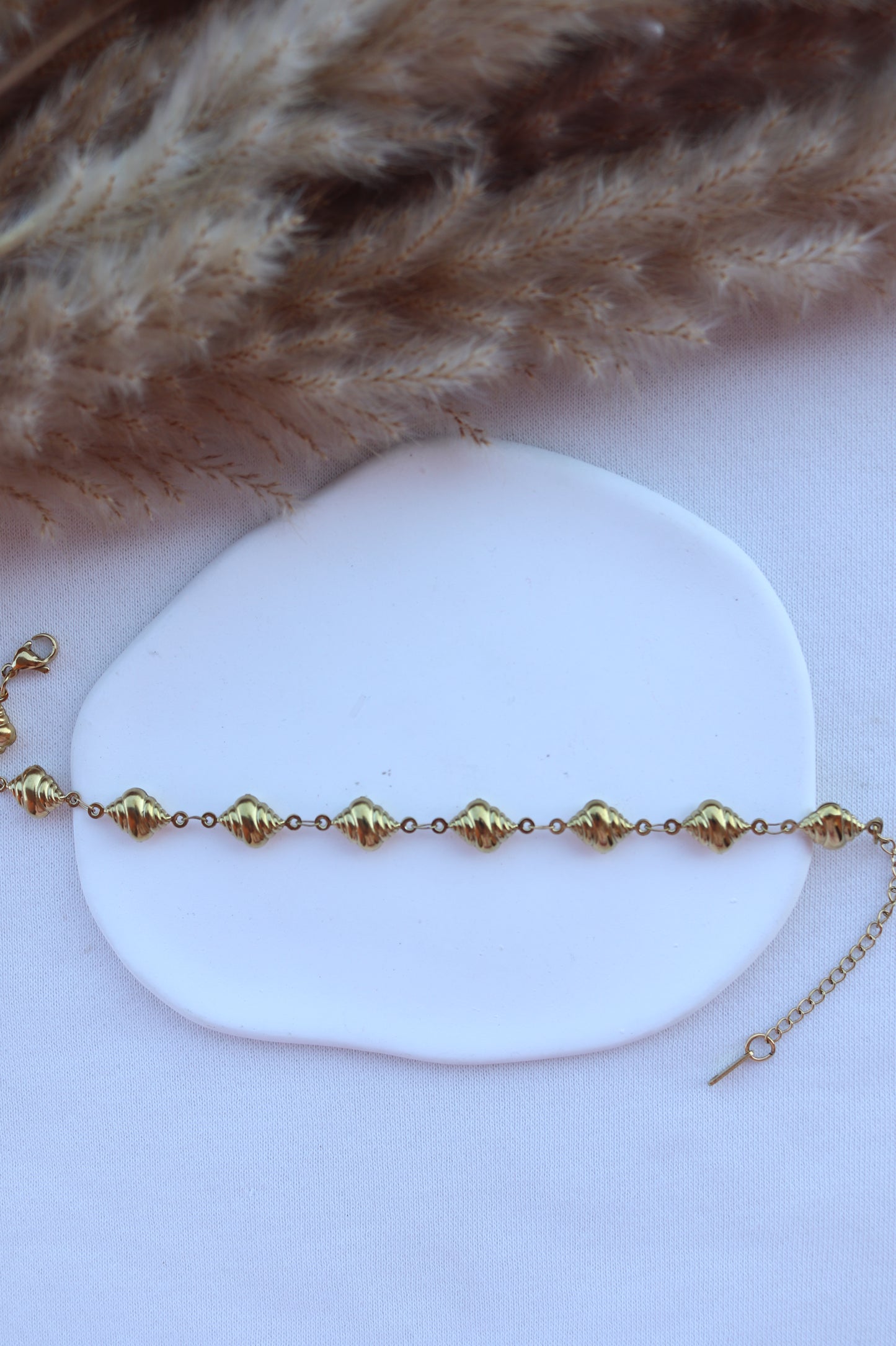 Pulseira de Aço Dourado de Pé de Búzios