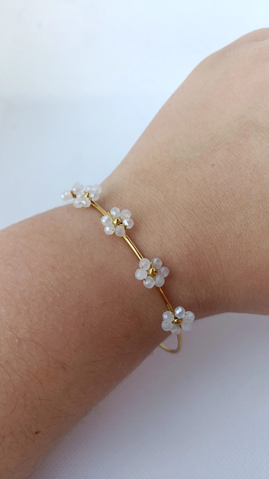 Pulseira de Aço Dourado Rígida com 5 Flores Brancas